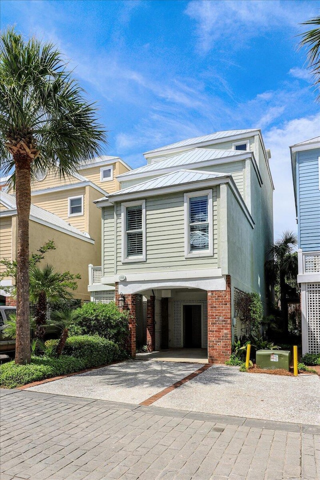 103 Grand Pavilion Blvd, Isle Of Palms, SC 29451 - view of front facade with a carport, driveway, and brick siding