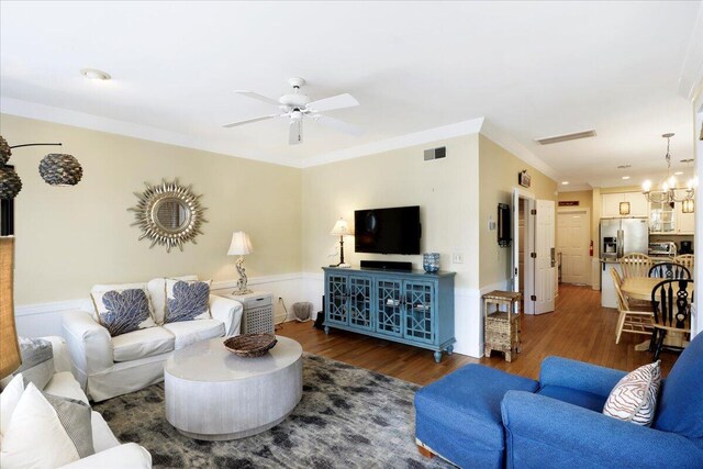 103 Grand Pavilion Blvd, Isle Of Palms, SC 29451 - living area with ceiling fan with notable chandelier, wood finished floors, visible vents, and ornamental molding