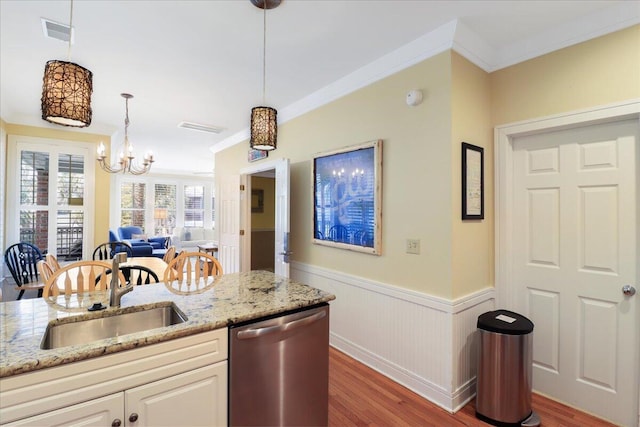 103 Grand Pavilion Blvd, Isle Of Palms, SC 29451 - kitchen with stainless steel dishwasher, a sink, wainscoting, visible vents, and wood finished floors