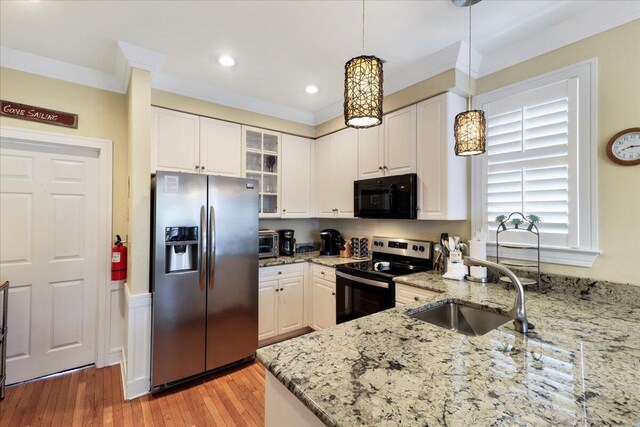 103 Grand Pavilion Blvd, Isle Of Palms, SC 29451 - kitchen with ornamental molding, a sink, glass insert cabinets, appliances with stainless steel finishes, and white cabinetry