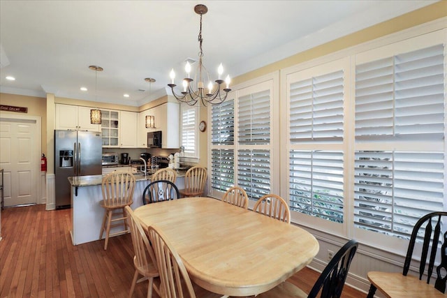 103 Grand Pavilion Blvd, Isle Of Palms, SC 29451 - dining room with a toaster, a healthy amount of sunlight, a chandelier, and dark wood-type flooring