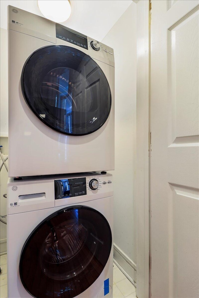 103 Grand Pavilion Blvd, Isle Of Palms, SC 29451 - laundry area featuring baseboards, stacked washer / drying machine, tile patterned floors, and laundry area