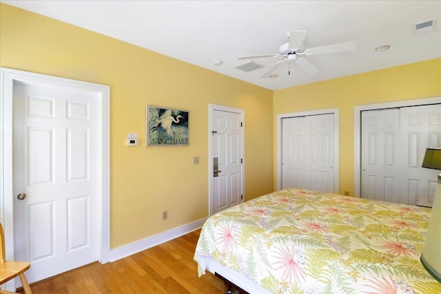 103 Grand Pavilion Blvd, Isle Of Palms, SC 29451 - bedroom with two closets, baseboards, visible vents, and light wood-type flooring