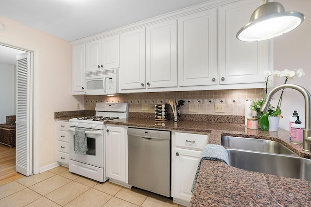 kitchen featuring sink, white appliances, white cabinets, and decorative backsplash