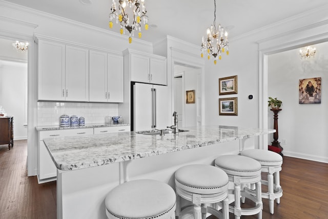 3998 Capensis Ln, Ravenel, SC 29470 - kitchen with a chandelier, freestanding refrigerator, a sink, dark wood-style floors, and crown molding