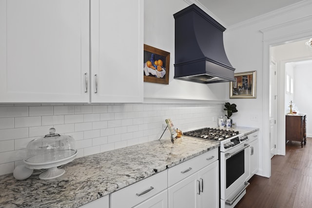 3998 Capensis Ln, Ravenel, SC 29470 - kitchen featuring white gas range, premium range hood, ornamental molding, light stone counters, and white cabinets