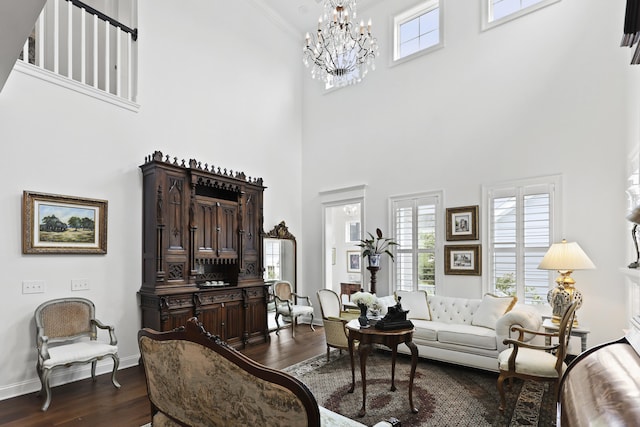 3998 Capensis Ln, Ravenel, SC 29470 - living room featuring a towering ceiling, dark wood-type flooring, a chandelier, baseboards, and ornamental molding