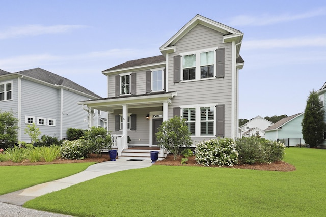 3998 Capensis Ln, Ravenel, SC 29470 - view of front facade with a porch and a front lawn