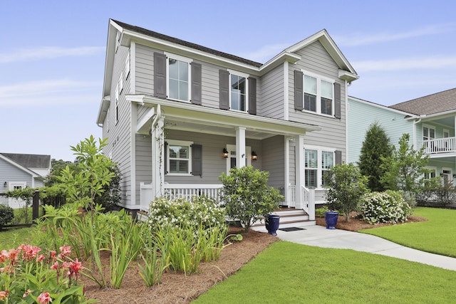 3998 Capensis Ln, Ravenel, SC 29470 - view of front of property featuring covered porch and a front lawn