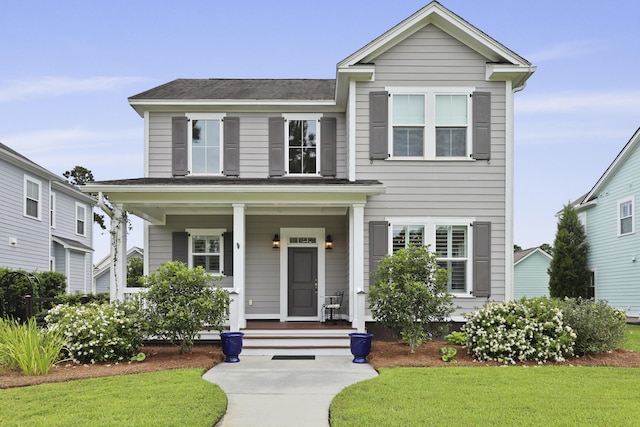 3998 Capensis Ln, Ravenel, SC 29470 - view of front of property featuring a porch, a front lawn, and roof with shingles