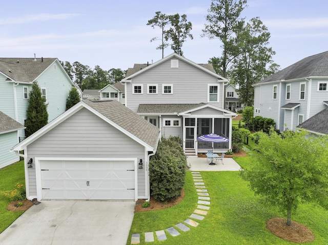 3998 Capensis Ln, Ravenel, SC 29470 - back of property featuring concrete driveway, a yard, an attached garage, a sunroom, and roof with shingles