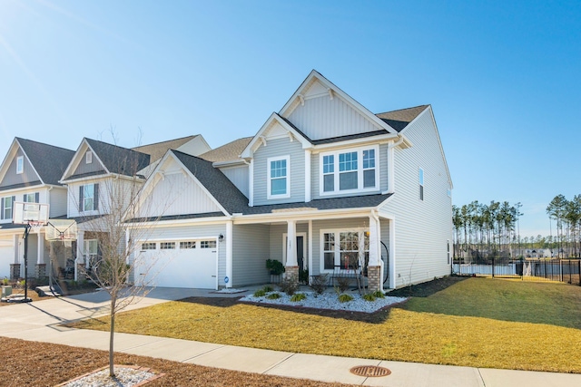 craftsman inspired home featuring a front yard, a porch, board and batten siding, and concrete driveway