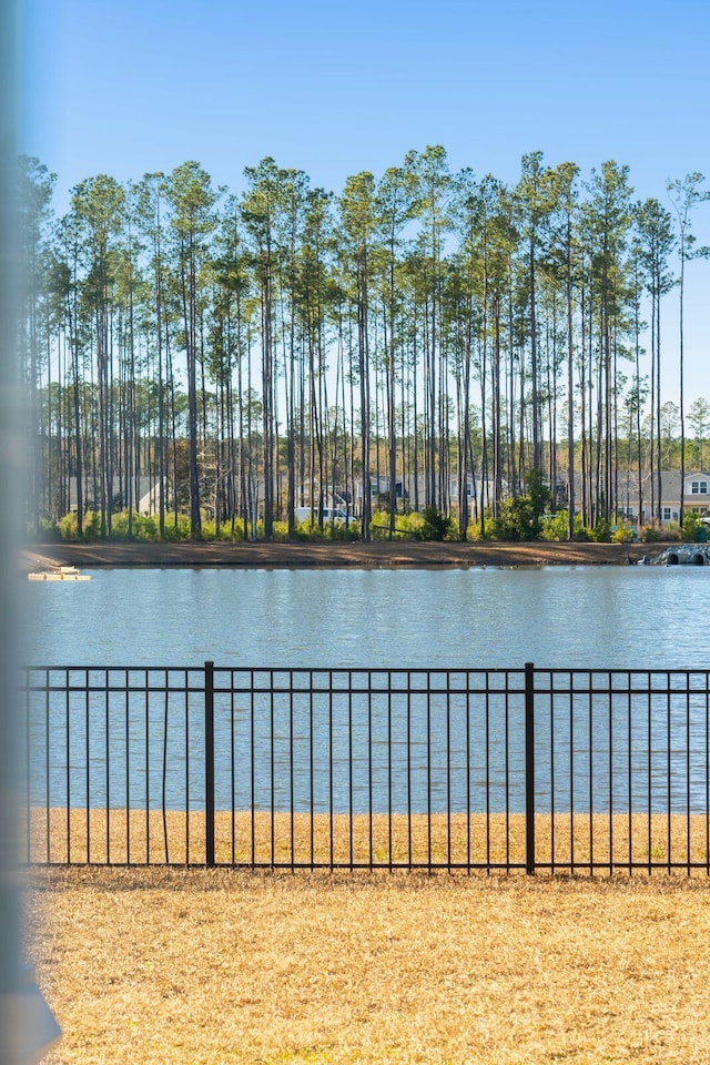 property view of water featuring fence