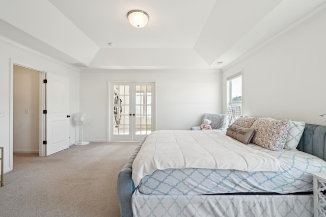 carpeted bedroom featuring baseboards, french doors, a raised ceiling, and crown molding