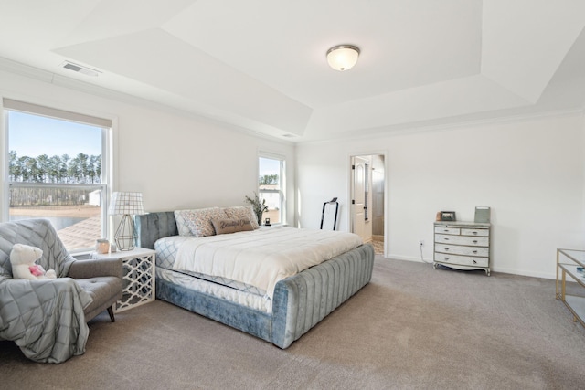 bedroom featuring light carpet, visible vents, baseboards, a tray ceiling, and crown molding