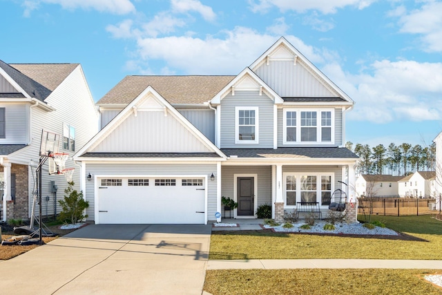 craftsman-style home featuring covered porch, concrete driveway, board and batten siding, and fence