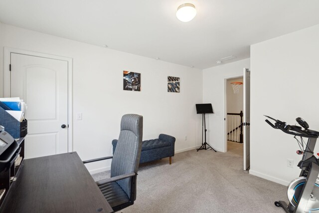 office with baseboards and light colored carpet