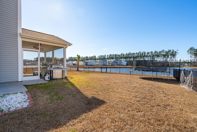 view of yard with a trampoline and a fenced backyard