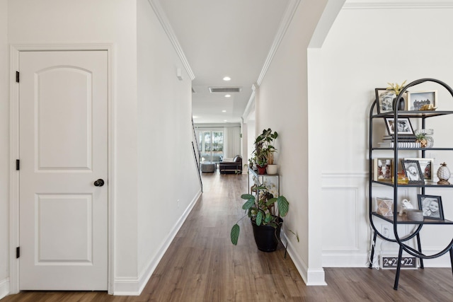 hallway with arched walkways, ornamental molding, dark wood-style flooring, and visible vents