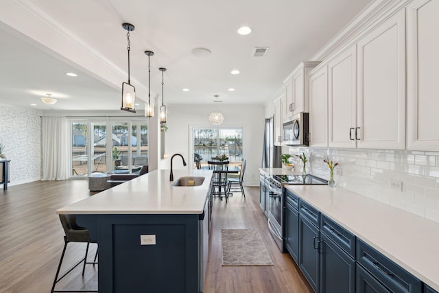 kitchen featuring light countertops, appliances with stainless steel finishes, visible vents, and white cabinets