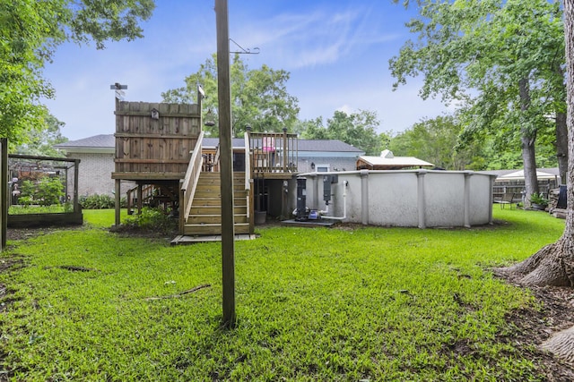 414 Birch Ave, Goose Creek, SC 29445 - rear view of house with a lawn, stairway, a deck, and an outdoor pool