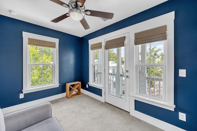 sitting room with carpet floors, baseboards, and a ceiling fan