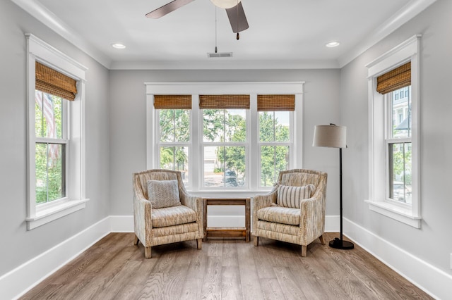 living area with recessed lighting, wood finished floors, visible vents, and baseboards