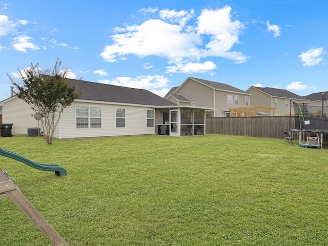 224 Market Hall St, Moncks Corner, SC 29461 - back of property with a trampoline, a sunroom, a playground, and a residential view
