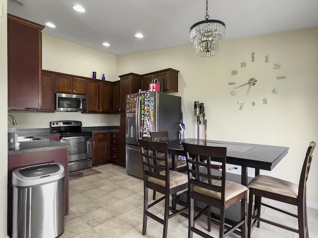 224 Market Hall St, Moncks Corner, SC 29461 - kitchen featuring appliances with stainless steel finishes, a sink, dark countertops, a chandelier, and recessed lighting