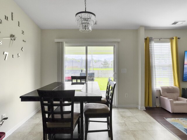 224 Market Hall St, Moncks Corner, SC 29461 - dining area with a chandelier, baseboards, and light tile patterned flooring