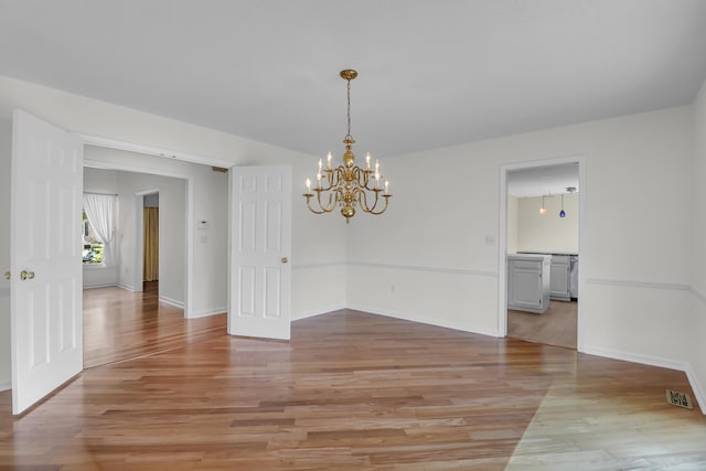 919 Overview Ct, Mount Pleasant, SC 29464 - spare room with a chandelier, light wood-style floors, and baseboards