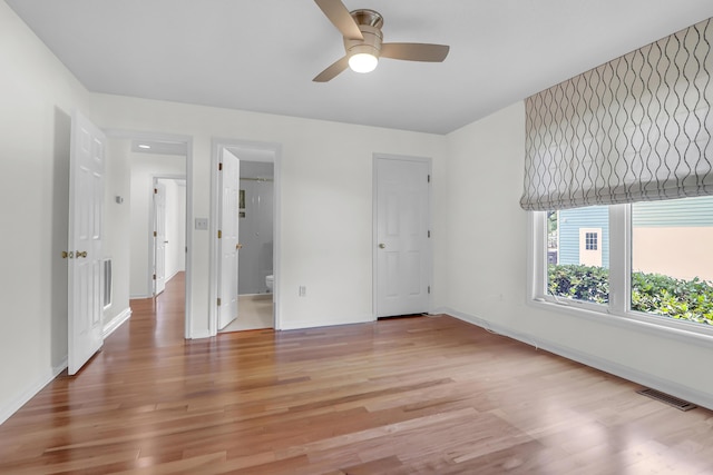 919 Overview Ct, Mount Pleasant, SC 29464 - unfurnished bedroom featuring baseboards, light wood finished floors, connected bathroom, and a ceiling fan