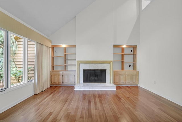 919 Overview Ct, Mount Pleasant, SC 29464 - unfurnished living room featuring high vaulted ceiling, light wood-style flooring, a fireplace, baseboards, and built in shelves