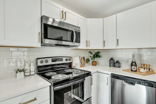 kitchen featuring backsplash, appliances with stainless steel finishes, and white cabinetry