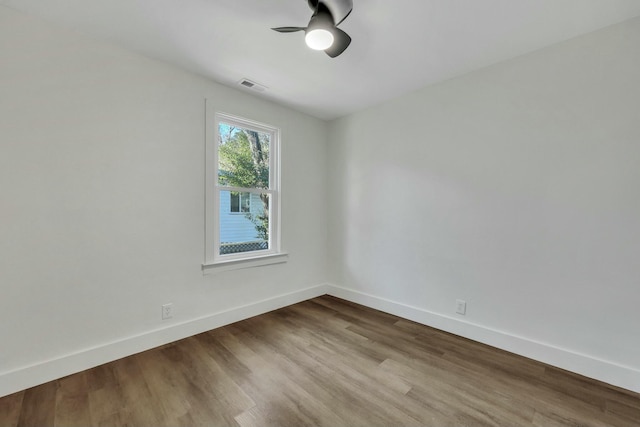 empty room featuring hardwood / wood-style flooring and ceiling fan