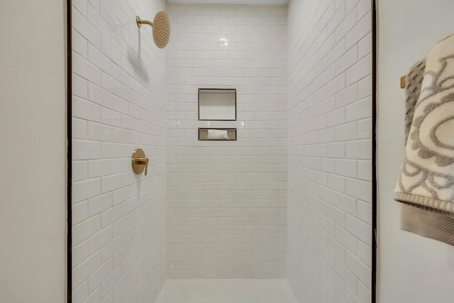 bathroom with a tile shower