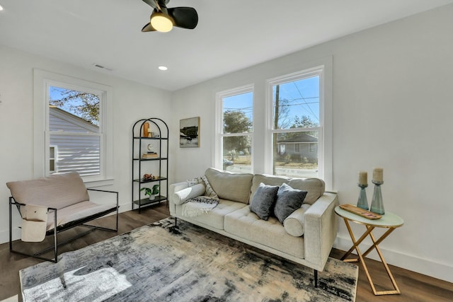 living room with ceiling fan and dark hardwood / wood-style flooring