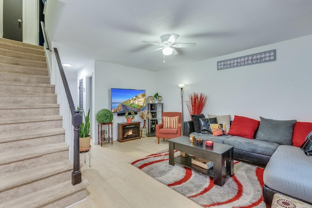 living room with ceiling fan and light wood-type flooring