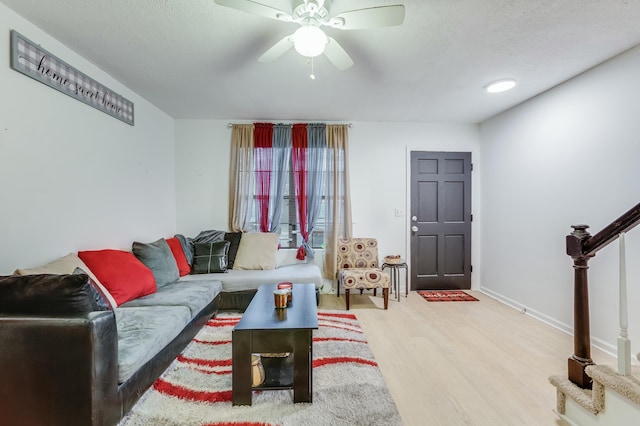 living room with light hardwood / wood-style flooring and ceiling fan