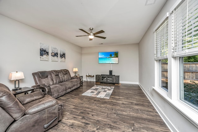 living room featuring ceiling fan and dark hardwood / wood-style flooring