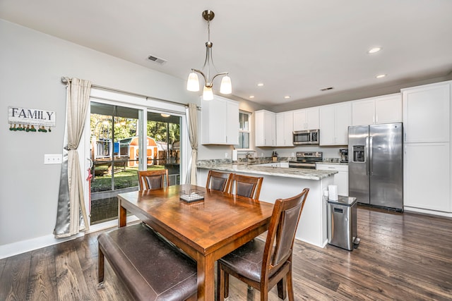 dining space featuring a chandelier and dark hardwood / wood-style floors