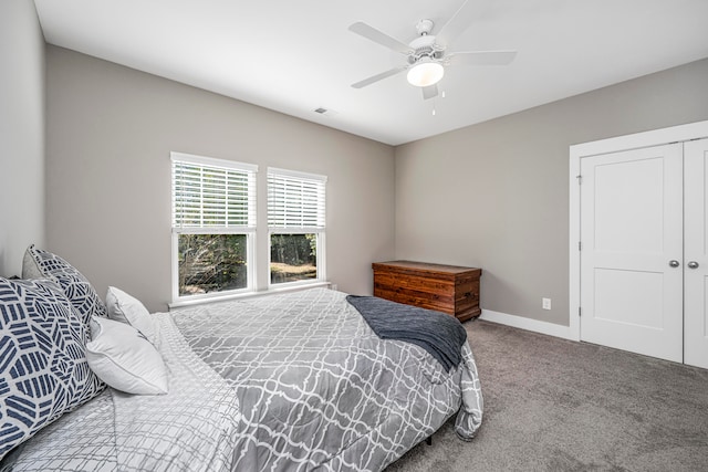 carpeted bedroom featuring a closet and ceiling fan