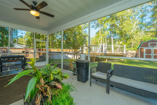 sunroom featuring ceiling fan