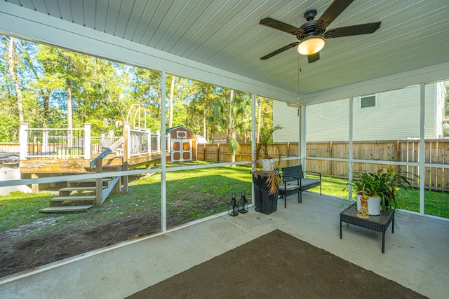 unfurnished sunroom featuring ceiling fan