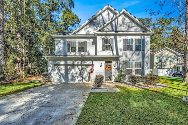 view of property featuring a front yard and a garage