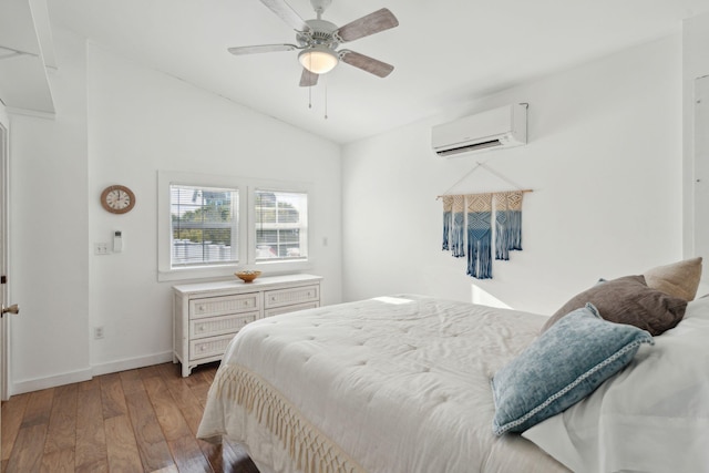 bedroom with ceiling fan, light hardwood / wood-style floors, lofted ceiling, and a wall unit AC