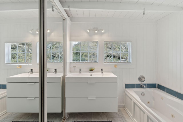 bathroom with wooden ceiling, vanity, a wealth of natural light, and beamed ceiling