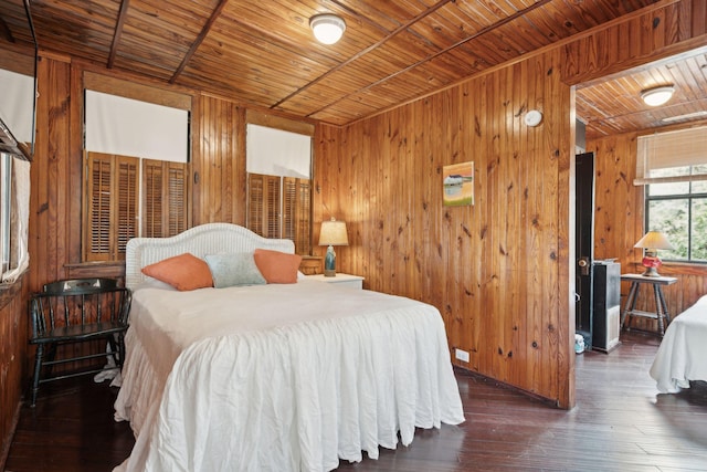 bedroom featuring dark wood-type flooring, wooden ceiling, and wooden walls