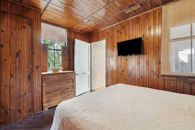 bedroom featuring wooden walls and wood ceiling