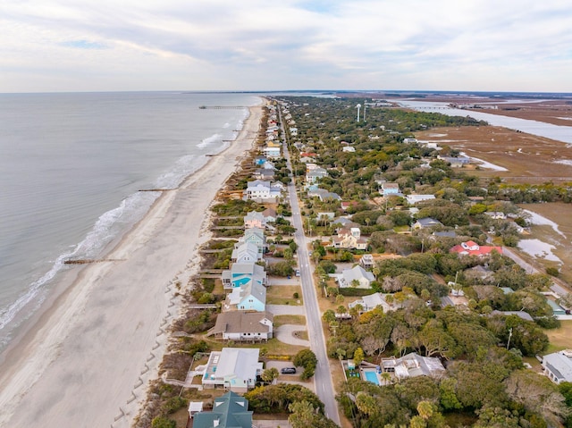 birds eye view of property with a beach view and a water view